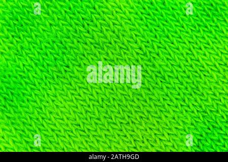 image background from a canvas of green color knitted with woolen threads of green Stock Photo