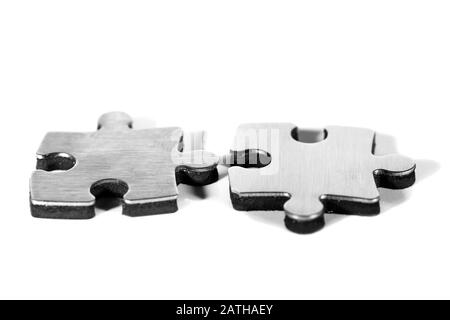 Two puzzle pieces are put together, isolated against white background Stock Photo