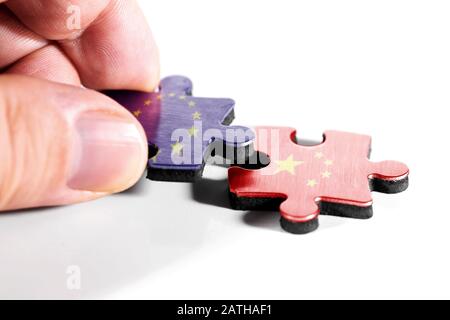 Two puzzle pieces with flags of China and Europe on abstract background ...