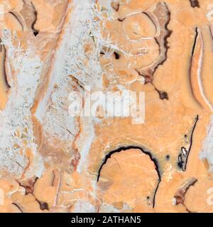 Beautiful brown natural stone bacground. Seamless square texture, tile ready. Stock Photo