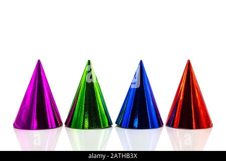 Four colorful party hats with reflections, isolated on white background, Birthday party and silvester decoration Stock Photo