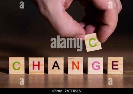 Hand puts a letter and shows that change is a chance at the same time Stock Photo