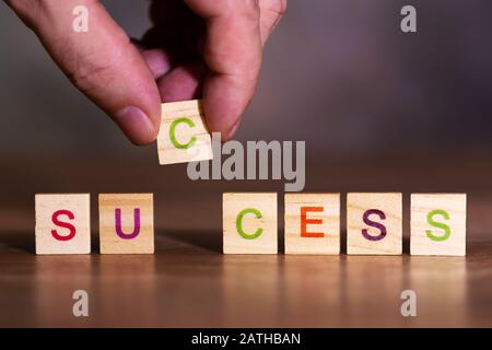 The word success, made up of many colorful letters on wooden blocks Stock Photo