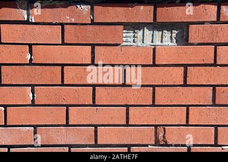 Garden wall with missing a brick Stock Photo