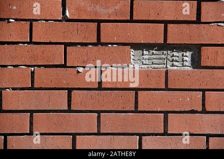 Garden wall with missing a brick Stock Photo