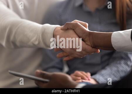 Hands of multi-ethnic people shake hands close up view Stock Photo
