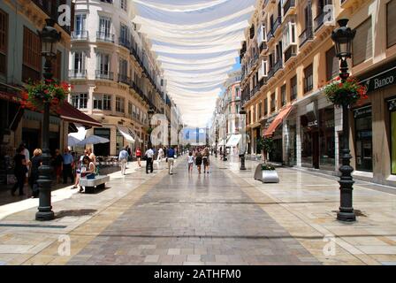 Shops and shoppers along the Calle Marques de Larios main shopping street in the city centre, Malaga, Spain. Stock Photo