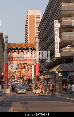 Late afternoon, summer in Melbourne looking up Little Bourke Street and one (Russell St) of five gates that encompass the China Town precinct. Stock Photo