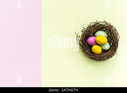 Easter Eggs in a nest with a colourful background Stock Photo