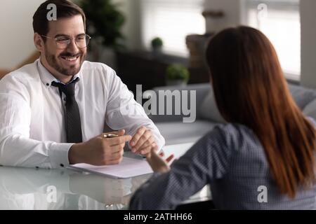 Company owner and female applicant communicating during job interview Stock Photo