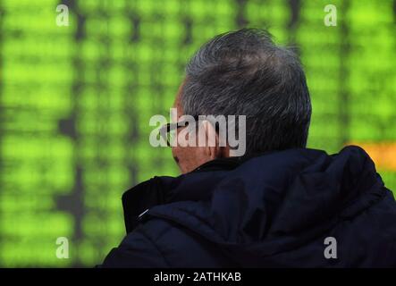 A Chinese investor is concerned about prices of shares at a stock brokerage house in Hangzhou City, east China's Zhejiang Province on February 3rd, 20 Stock Photo