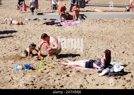 Benidorm, Alicante Province, Spain. 3rd February 2020. British tourists relaxing in the winter sun with locals and other tourists on Levante beach as the temperature reaches 22 centigrade. Credit: Mick Flynn/Alamy Live News Stock Photo