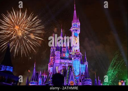 Orlando, USA - january 19, 2020: Purple magic kingdom castle with firework at night time Stock Photo