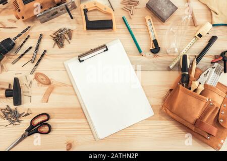 Woodwork carpentry mockup with tools and clipboard paper on workshop desk Stock Photo