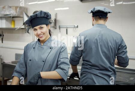 Cooks working in commercial kitchen Stock Photo