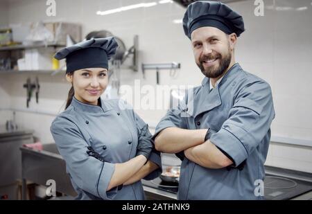 Two smiling crossed arms cooks Stock Photo