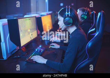 High angle view at young Asian man playing video games with pro cyber sport team, copy Stock Photo