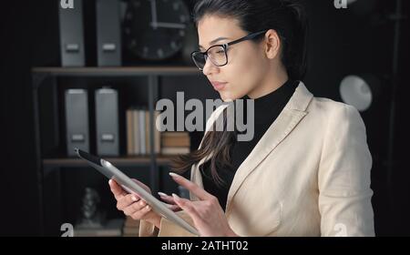 Businesswoman using electronic tab Stock Photo