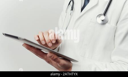 Doctor's hands using tablet Stock Photo