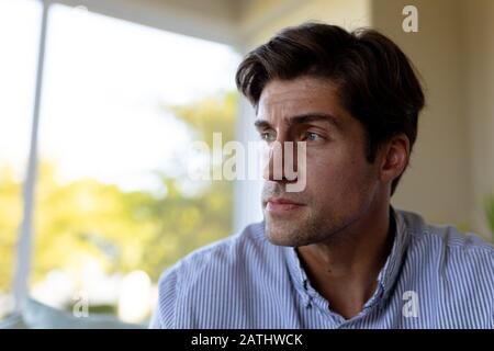 Young man at home looking away Stock Photo