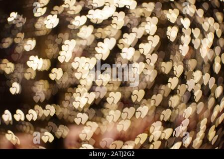 Big and small hearts bokeh lights. Beautiful valentines day background Stock Photo