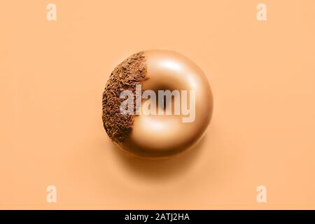 One donut with icing and chocolate on pastel light brown background. Sweet donuts. Stock Photo
