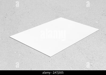 empty white rectangle poster mockup lying diagonally on neutral grey concrete background Stock Photo