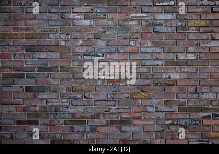 Brick wall, multi-colored decorated brick wall close-up Stock Photo