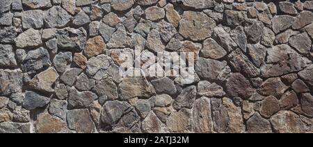 Stonewall, wall decorated with natural stone, close-up Stock Photo