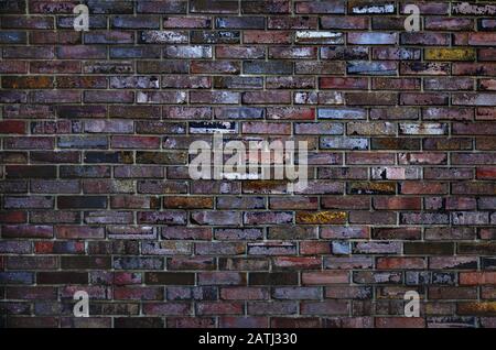 Brick wall, multi-colored decorated brick wall close-up Stock Photo