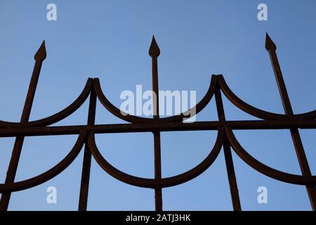 Forged fence against the blue sky, close-up Stock Photo