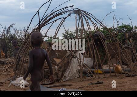 Omorate, Ethiopia - Nov 2018: Dasanech tribe women constructing a house in  the village. Omo valley Stock Photo