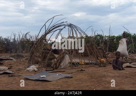 Omorate, Ethiopia - Nov 2018: Dasanech tribe women constructing a house in  the village. Omo valley Stock Photo