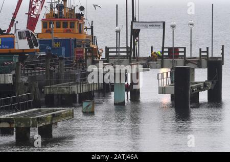 Koserow, Germany. 03rd Feb, 2020. A mobile crane is used to dismantle the pier built in 1993 in the Baltic resort of Koserow. A new pier is to be built by August 2020. It should also rise about 280 metres into the sea, but look completely different from other sea bridges from the Baltic Sea and be barrier-free. According to the plans, the special features are, in addition to a wave appearance in the top view, an almost square bridgehead with a bell tower. The new building is to cost 7.4 million euros. The construction is financed with the help of EU funds. Credit: Stefan/dpa/Alamy Live News Stock Photo