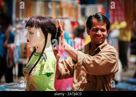 hairdresser practising on a street dummy Stock Photo