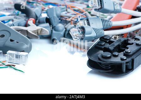 Tools and cables used in service of network ethernet patch cord Stock Photo