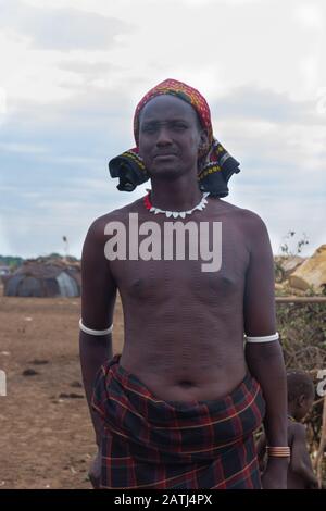 Omorate, Ethiopia - Nov 2018: Dasanech tribe man with cuts in his body proudly standing. Omo valley Stock Photo