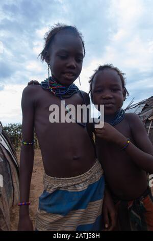 Omorate, Ethiopia - Nov 2018: Dasanech tribe kids playing in the village. Omo valley Stock Photo