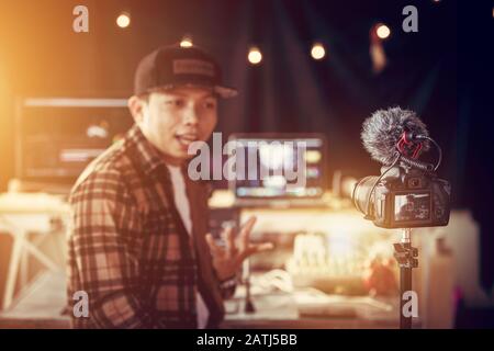 Asian male vlogger contents creator talking and looking in camera recording for blog Stock Photo