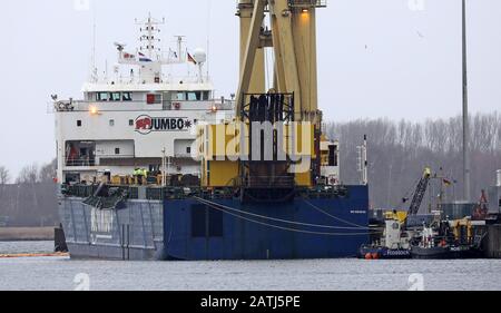 Rostock, Germany. 03rd Feb, 2020. In the seaport lies the heavy lift vessel "Jumbo Vision" sailing under the Dutch flag, from which two mobile harbour cranes fell into the harbour basin during loading in an accident on 31.01.2020. The cranes cost between three and five million euros - depending on their equipment -, weigh around 440 tonnes each and have a reach of up to 54 metres. A salvage concept is currently being worked on, but a concrete lifting date has not yet been fixed. Credit: Bernd Wüstneck/dpa-Zentralbild/dpa/Alamy Live News Stock Photo