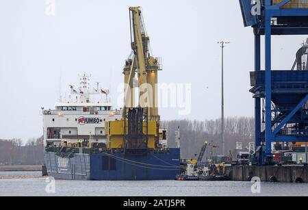 Rostock, Germany. 03rd Feb, 2020. In the seaport lies the heavy lift vessel "Jumbo Vision" sailing under the Dutch flag, from which two mobile harbour cranes fell into the harbour basin during loading in an accident on 31.01.2020. The cranes cost between three and five million euros - depending on their equipment -, weigh around 440 tonnes each and have a reach of up to 54 metres. A salvage concept is currently being worked on, but a concrete lifting date has not yet been fixed. Credit: Bernd Wüstneck/dpa-Zentralbild/dpa/Alamy Live News Stock Photo