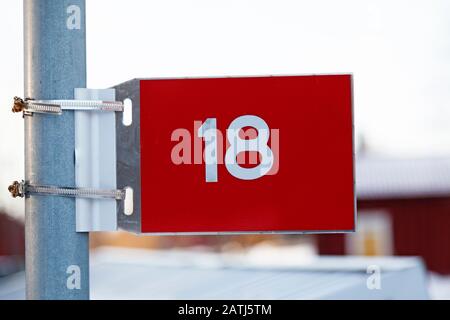 a plate with the figure eighteen in red and white Stock Photo