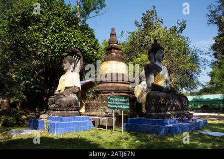 SARABURI, THAILAND - NOVEMBER 26 : Three buddha statue in pagoda for thai people and foreign travelers visit and respect praying at Wat Pa Sawang Bun Stock Photo