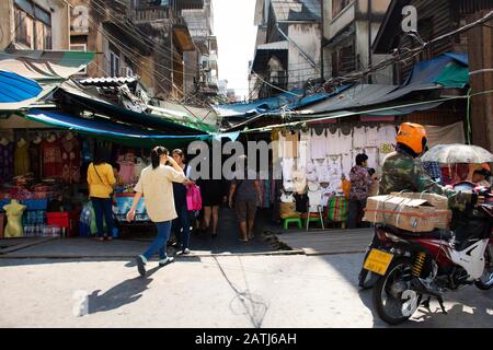 BANGKOK, THAILAND - DECEMBER 3 : Thai people walking select and buying fabric material with accessories from garment shop in Sampeng plaza and Phahura Stock Photo