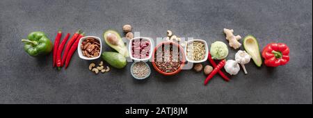 Healthy food clean eating selection: vegetable, seeds, superfood, leaf vegetable on gray concrete background Stock Photo