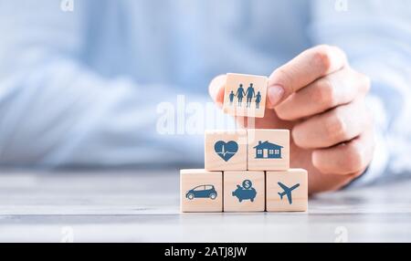 Wooden blocks with icons of various types of insurance. Life insurance concept. Stock Photo