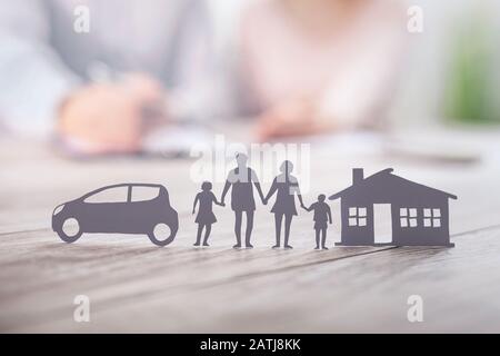 Insurance protecting family health live, house and car concept. Cut elements from paper that symbolize the coverage. Stock Photo