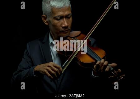 Professional violins senior playing close up musician Stock Photo