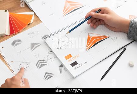 Graphic designer drawing sketches logo design. The concept of a new brand. Professional creative occupation with idea. Stock Photo