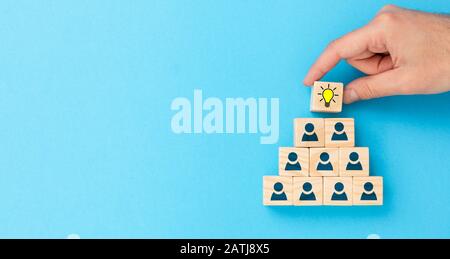 Wooden cubes with icon light bulb and human symbol. Creative idea and innovation concept. Stock Photo